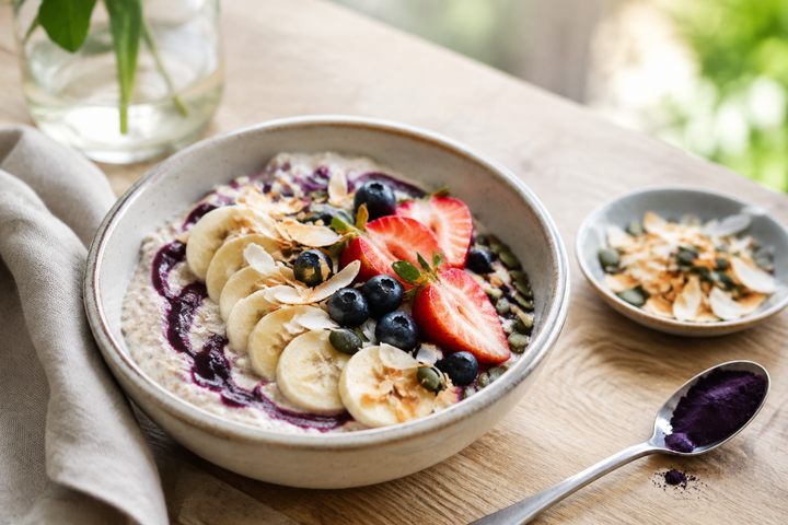 Açaí berry overnight oats topped with banana, berries, coconut and seeds