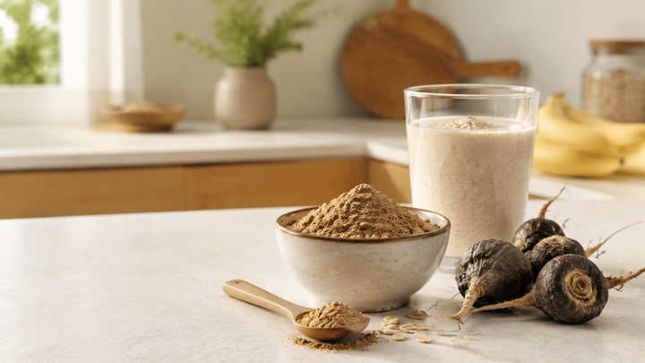 Black maca powder with a creamy oat smoothie in a bright kitchen