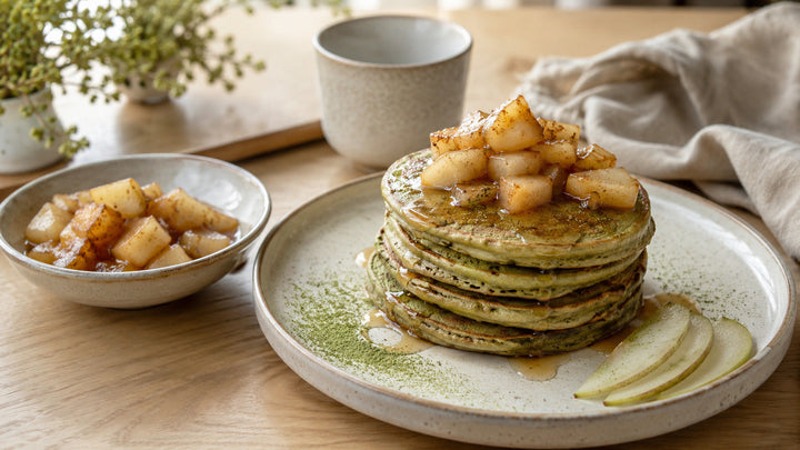 Stack of matcha pancakes topped with warm cinnamon pears