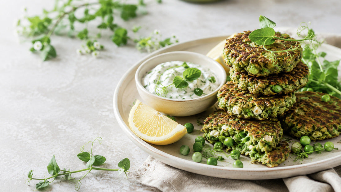 Super greens pea and feta fritters with lemon-herb yoghurt, fresh peas and lemon